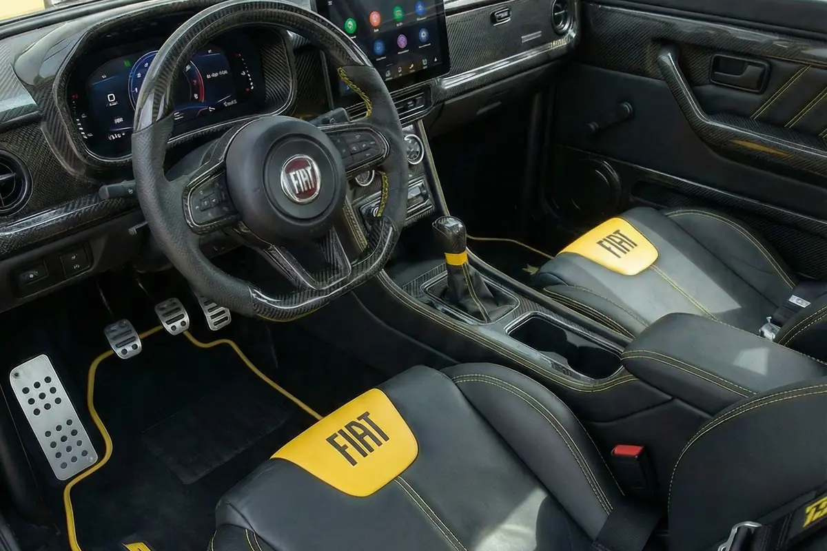Interior moderno com volante, bancos esportivos FIAT, painel digital e tela multimídia central.